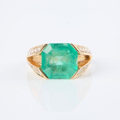 Gold ring set with an emerald-cut emerald...
