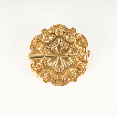 Gold brooch with radiating decoration centered...