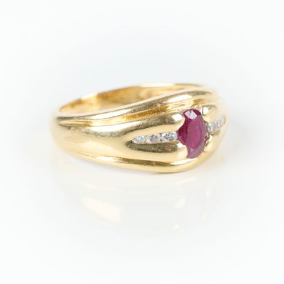 Gold ring set with an oval-cut ruby and 6...