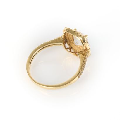 Yellow gold ring centered with a zircon in...