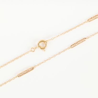 Gold chain with oval links interspersed with...