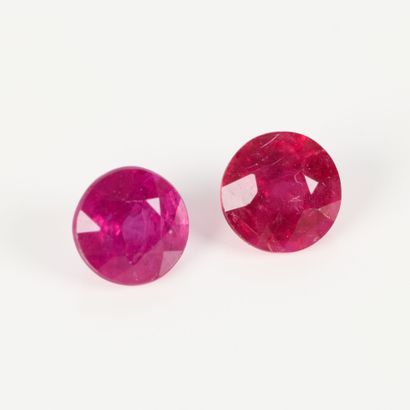 Two round rubies on paper, each weighing...
