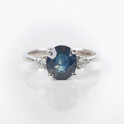 White gold ring set with an oval sapphire...