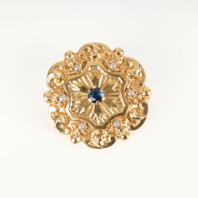 Gold brooch with radiating decoration centered...