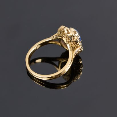 Gold ring set with an oval sapphire weighing...