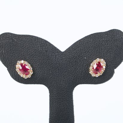 Pair of yellow gold (750‰) ear studs, each...