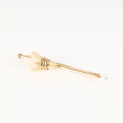 Gold brooch (750‰), set with 2 deer teeth....