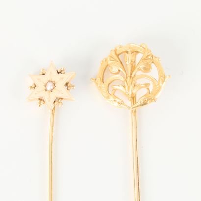 Two gold tie pins, one with a star motif...