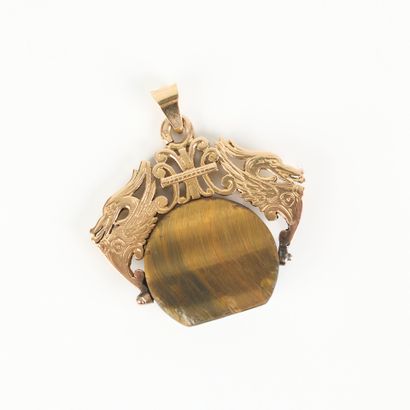 Gold pendant holding a tiger's eye decorated...
