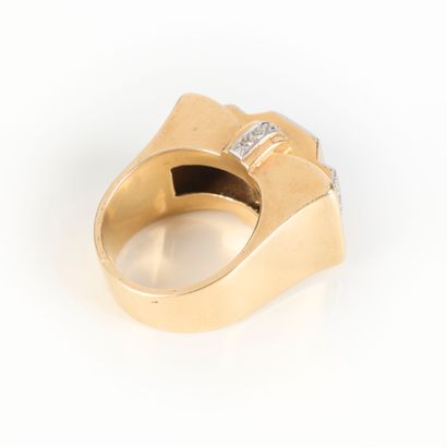 A striking tank-style ring in gold and platinum,...