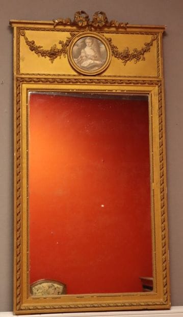 Molded, carved, and gilded wooden trumeau...
