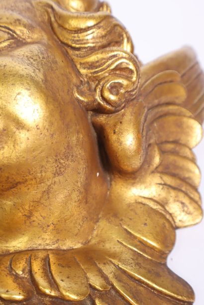 Terracotta piece decorated with a cherub's...