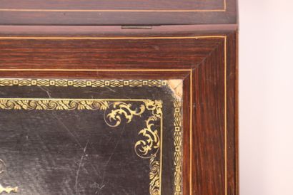 A veneered wooden writing desk with light-colored...