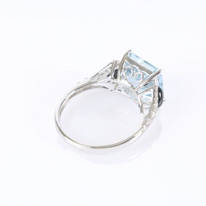 White gold ring set with a princess-cut aquamarine...