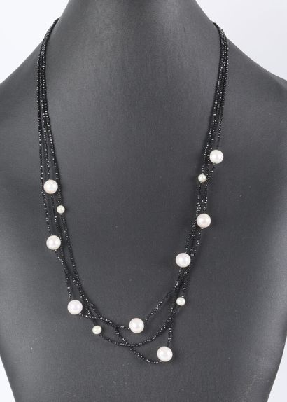 Three-strand necklace adorned with black...
