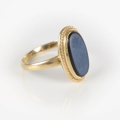 Gold ring set with an oval-shaped jet stone....