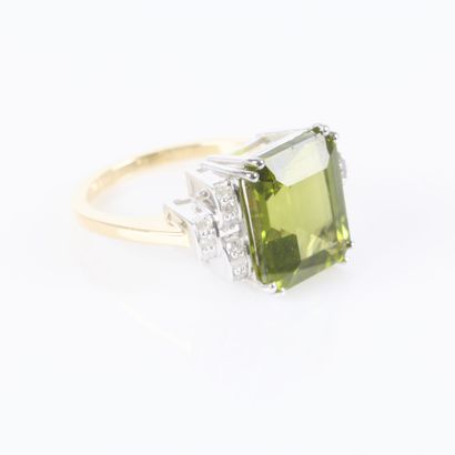 Two-tone gold ring set with an emerald-cut...