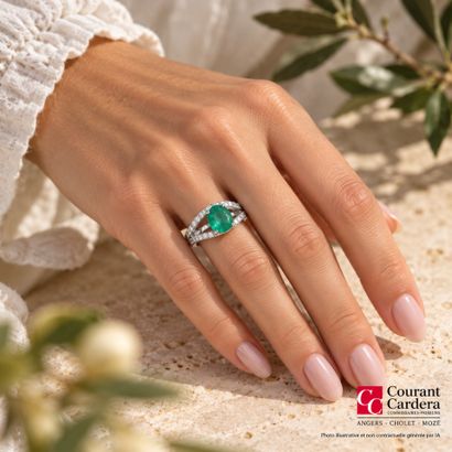 White gold ring set with an oval-cut emerald...