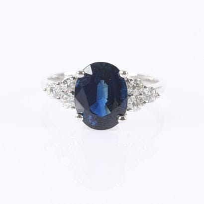 White gold ring set with an unheated oval-cut...