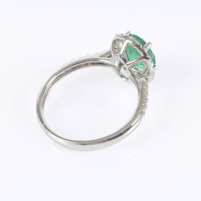White gold ring set with an oval-cut emerald...