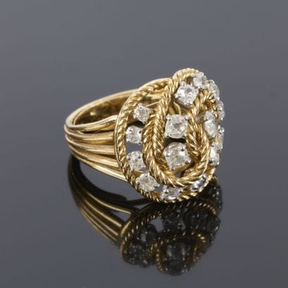 Gold and platinum ring featuring a twisted...