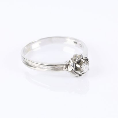 White gold solitaire ring centered with a...