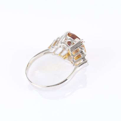 White gold ring set with a treated orange...