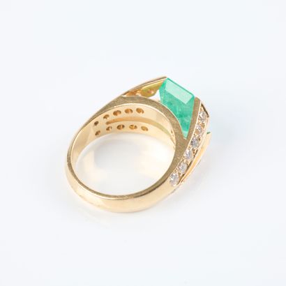 Gold ring set with an emerald-cut emerald...