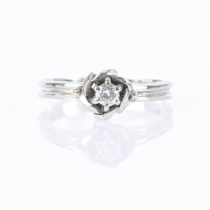 White gold solitaire ring centered with a...
