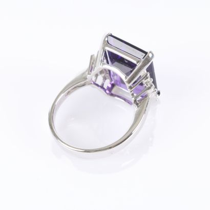 Stunning white gold ring set with an emerald-cut...