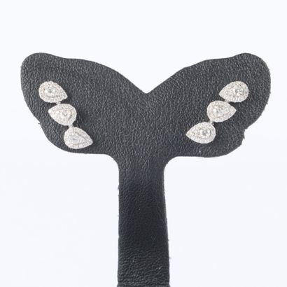 Pair of white gold earrings, each set with...