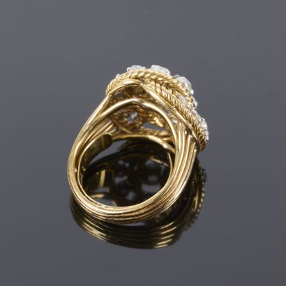 Gold and platinum ring featuring a twisted...