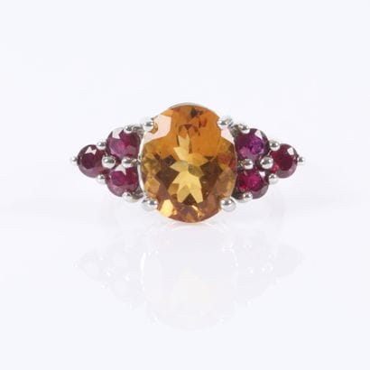 White gold ring set with an oval-cut citrine...