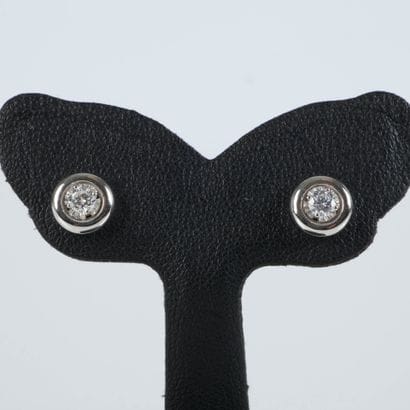 Pair of white gold earrings, each set with...