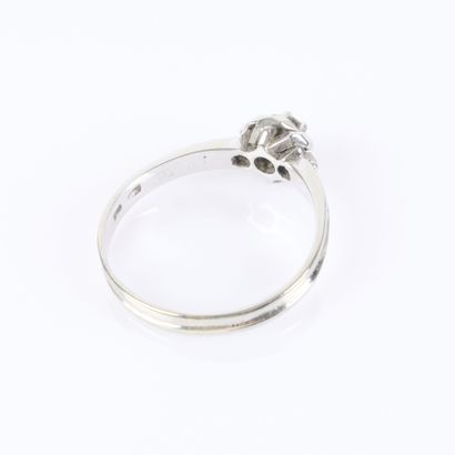 White gold solitaire ring centered with a...