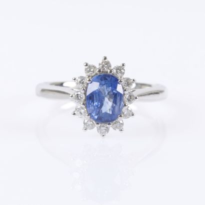 Platinum daisy ring set with an oval-cut...