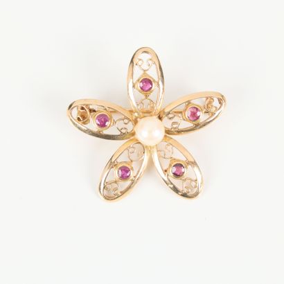 Gold flower brooch set with small rubies...