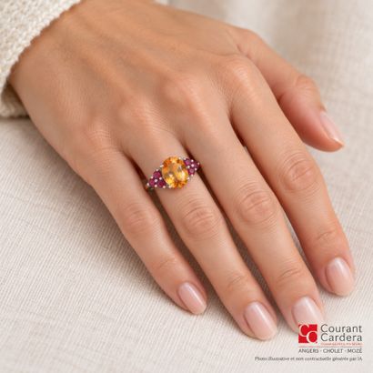 White gold ring set with an oval-cut citrine...
