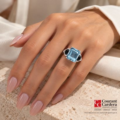 White gold ring set with a princess-cut aquamarine...