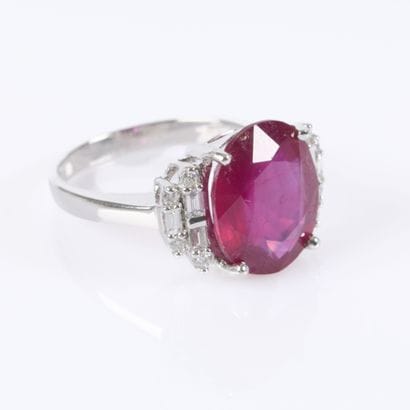 White gold ring set with a treated oval-cut...