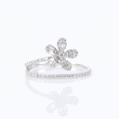 A delicate white gold ring featuring a row...