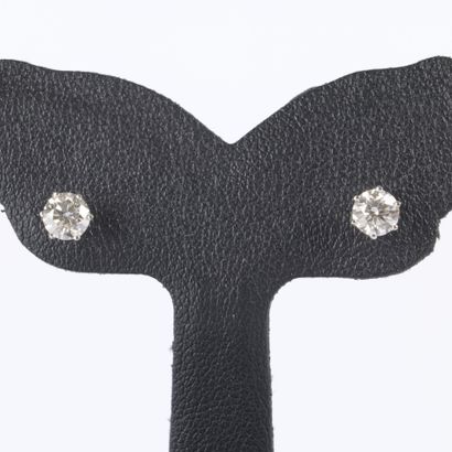 Pair of white gold earrings, each set with...