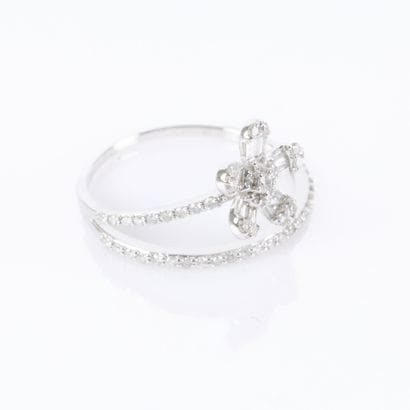A delicate white gold ring featuring a row...