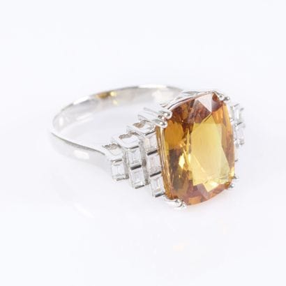 White gold ring set with a treated orange...