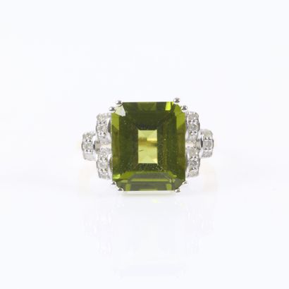 Two-tone gold ring set with an emerald-cut...