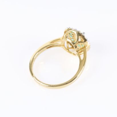 Gold ring set with an oval-cut diamond weighing...