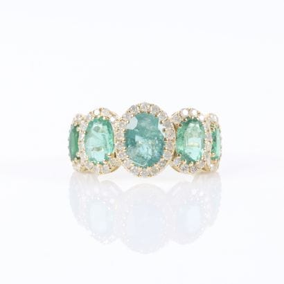 Gold ring set with a cascading row of 5 oval-cut...