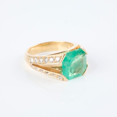 Gold ring set with an emerald-cut emerald...