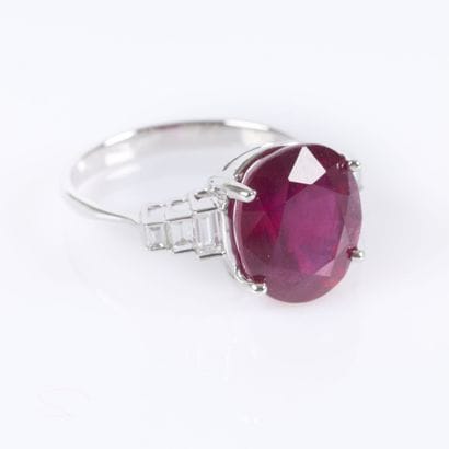 White gold ring set with a treated oval-cut...