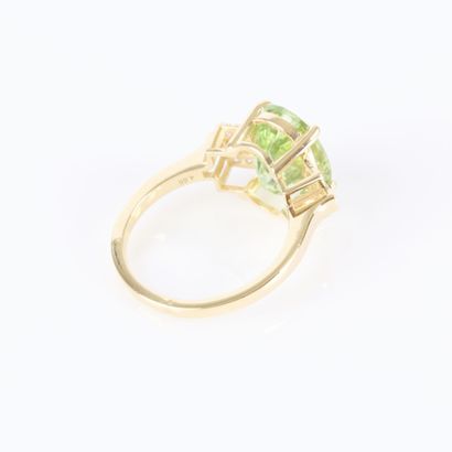 Gold ring set with an oval-cut green tourmaline...
